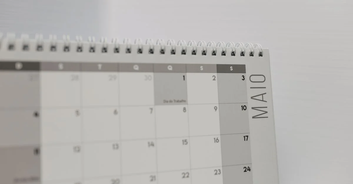 Calendrier à spirales indiquant le mois de mai avec un accent sur les jours de la semaine en portugais.